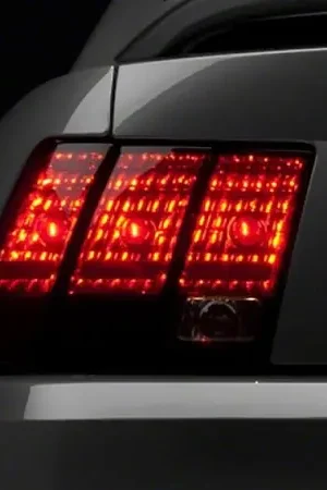 Deal Raxiom 99-04 Ford Mustang Excluding 99-01 Cobra Tail Lights- Black Housing (Smoked Lens)